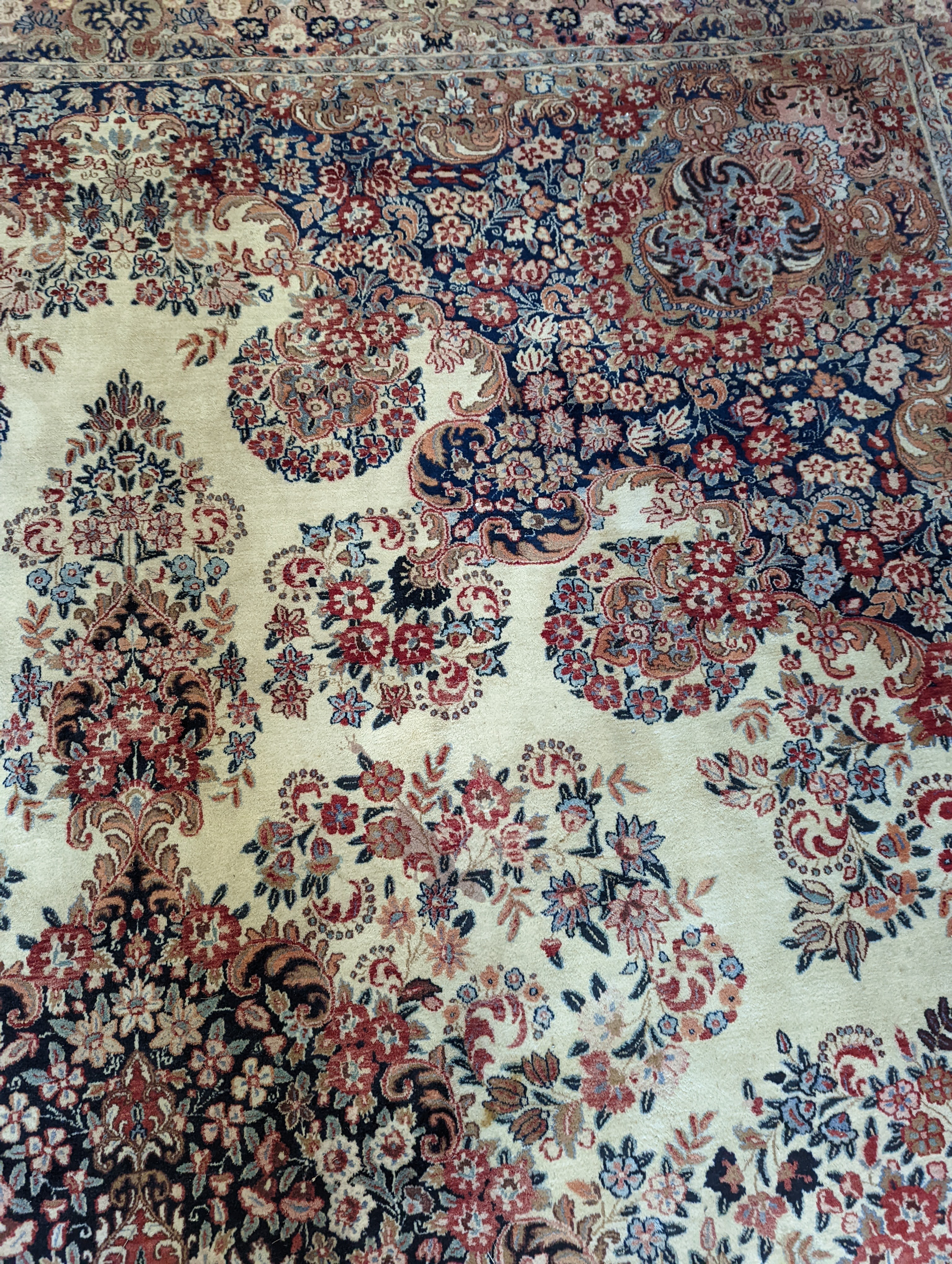 A North West Persian ivory ground carpet, 410 x 310cm